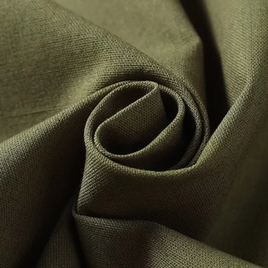 Close-up of olive green cotton linen fabric with a dense weave and natural texture