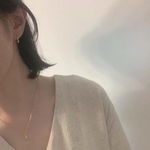Detail of 925 sterling silver gold teardrop necklace and earring set on model