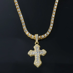 Detailed macro view of hip hop cross pendant with glittering clear crystals on gold chain
