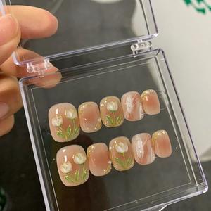 Handmade peach blush press-on nails with 3D white tulips and pearls in a clear display box