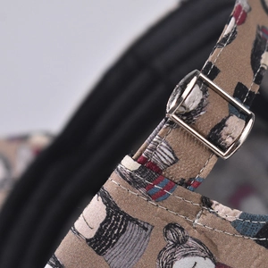 Detailed macro view of the adjustable silver metal buckle and printed fabric on baseball cap