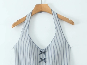 Close-up of blue and white striped halter dress with bow accents and lace trim