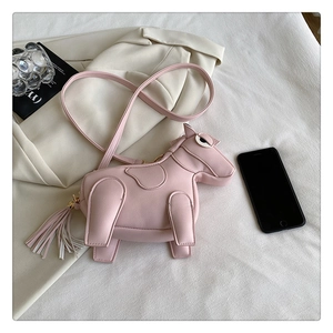 Pink PU leather horse-shaped crossbody bag with fringe tassel on stylish blazer background