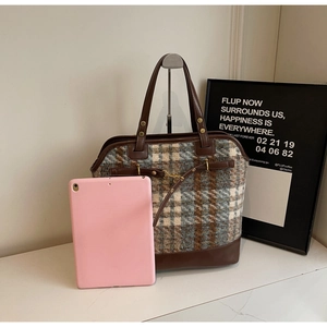 Detail of large retro plaid tote bag showing texture with tablet for size reference
