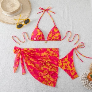 Detailed flat lay of a 3-piece floral bikini with tropical print and a matching sarong