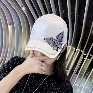 White satin baseball cap with sparkling rhinestone butterfly and black mesh detail
