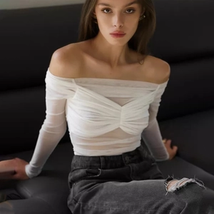 Close-up of white mesh off-shoulder long sleeve top with twist knot front detail