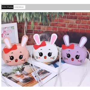 Detailed view of kids' cartoon rabbit crossbody bags in pink, white and purple variants