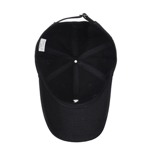 Internal view of a black cotton baseball cap showing reinforced seams and adjustable strap