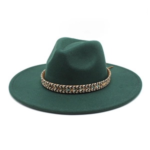 Detail of dark green wide brim fedora hat featuring an ethnic style woven decorative band