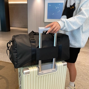 Versatile black travel bag with trolley sleeve mounted on a suitcase for fitness and travel