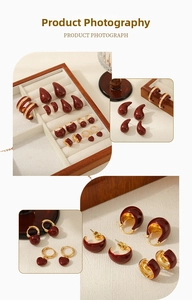 Detailed view of vintage burgundy enamel earrings collection with polished gold-tone metal finish