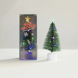 Detailed view of mini LED pine tree with glowing star topper and festive gift box