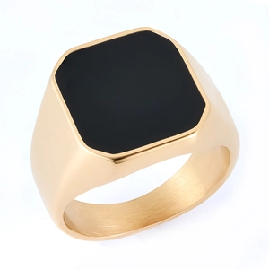 Close-up of a men's vintage gold stainless steel signet ring with black enamel inlay