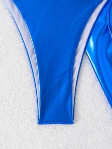 Macro detail of glossy blue metallic bikini bottom with premium white lining and stitching
