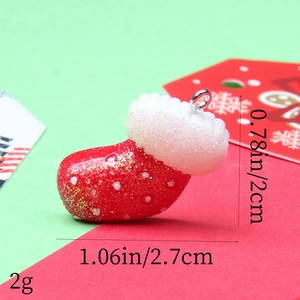Detail view of red glitter resin Christmas stocking pendant with size measurements