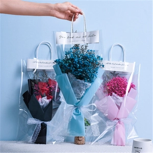 Preserved gypsophila and soap rose bouquets in elegant transparent gift bags with ribbons