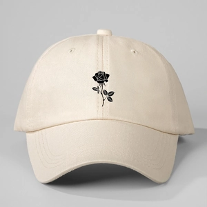 Front view of a beige baseball cap with a black rose print on high-quality cotton fabric