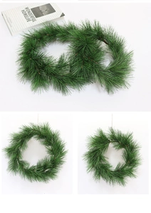 Detailed view of artificial green PVC pine needle wreaths for Christmas desktop decoration