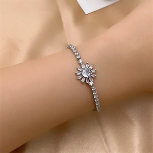 Detail of sunflower bracelet featuring marquise zircons on elegant champagne silk background