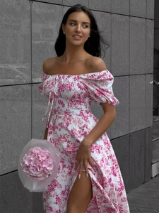 Detail of off-shoulder puff sleeves and pink floral print on a summer slit dress