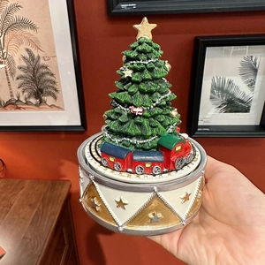 Classic Christmas tree music box with rotating train on festive drum base