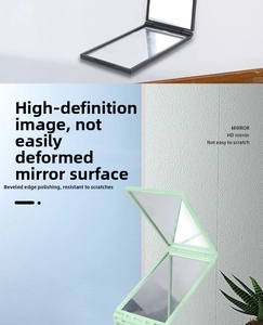 Detail view showing black and mint green four-way folding mirrors with polished edges