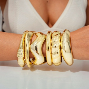 Minimalist gold irregular geometric bangles set in high polished metallic finish