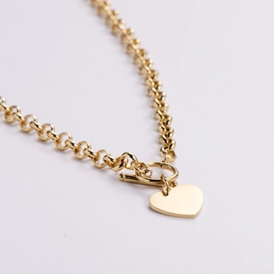 Polished gold heart pendant necklace with double layer link chain and toggle clasp