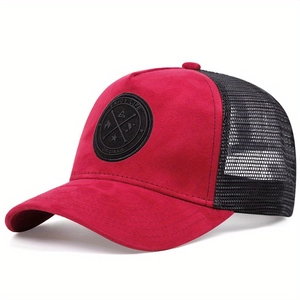 Detailed shot of red faux suede baseball cap with mesh back and circular logo patch