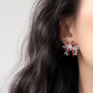 Nahaufnahme eleganter roter Feuerwerk Ohrstecker mit Zirkonia an einem weiblichen Model