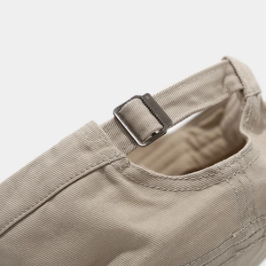 Detail of adjustable metal buckle and cotton twill texture on a flat top cadet hat