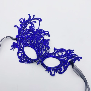 Macro view of dark blue lace masquerade mask with intricate embroidery and silk ribbons