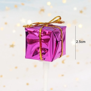 Close-up of a 2.5cm purple metallic gift box cake topper with golden ribbon bow detail
