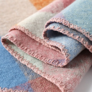 Macro shot of colorful block pattern scarf with soft texture and pink stitched edges