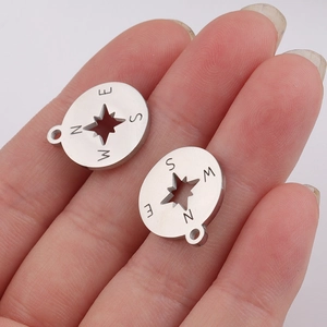 Stainless steel compass pendant charm with hollow star detail and engraved NSEW directions