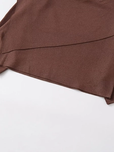 Detail of dark brown high-density knit fabric with asymmetric cut and fine texture