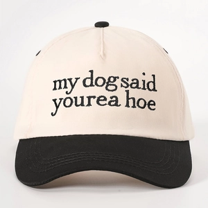 Two-tone baseball cap in beige and black featuring my dog said yourea hoe embroidery