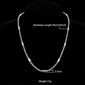 Silver stainless steel cylindrical link necklace for women displayed on a black mannequin