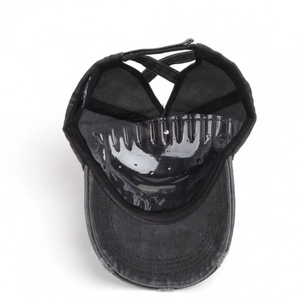 Detail view of washed cotton baseball cap with criss-cross back straps for high pony tails
