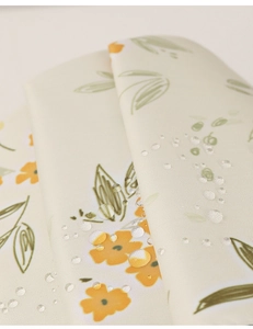 Macro shot of waterproof floral fabric with water droplets on high-density textile