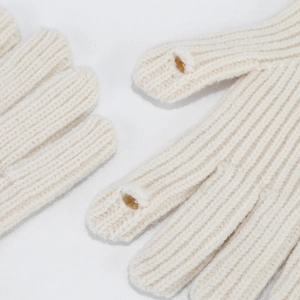 Detail of cream rib-knit wool gloves with finger opening for touch screen convenience
