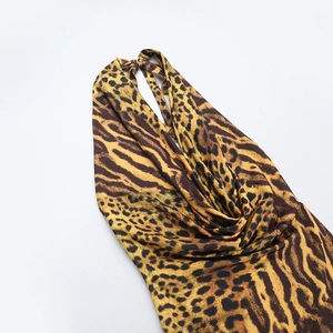 Detail of leopard print halter neckline with satin finish and elegant draped fabric