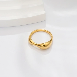 Detailed close-up of 18k gold wavy ring with irregular polished minimalist texture
