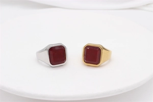 Macro detail of vintage signet rings with large octagonal red gemstones in gold and silver