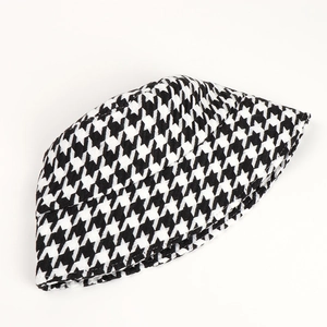 Close-up of black and white houndstooth bucket hat with thick winter texture detail