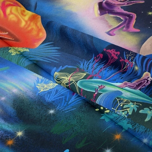 Detailed view of high-quality fabric texture featuring surreal mushroom astronaut print