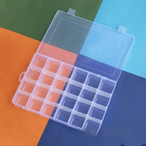 Macro view of a 24-compartment clear plastic storage box with secure hinged lid closure
