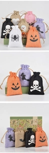 Close-up of Halloween linen drawstring bags featuring pumpkin and skull festive prints