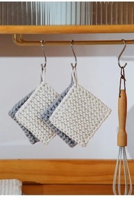 Detail of woven cotton heat resistant placemats with hanging loops in a cozy kitchen setting